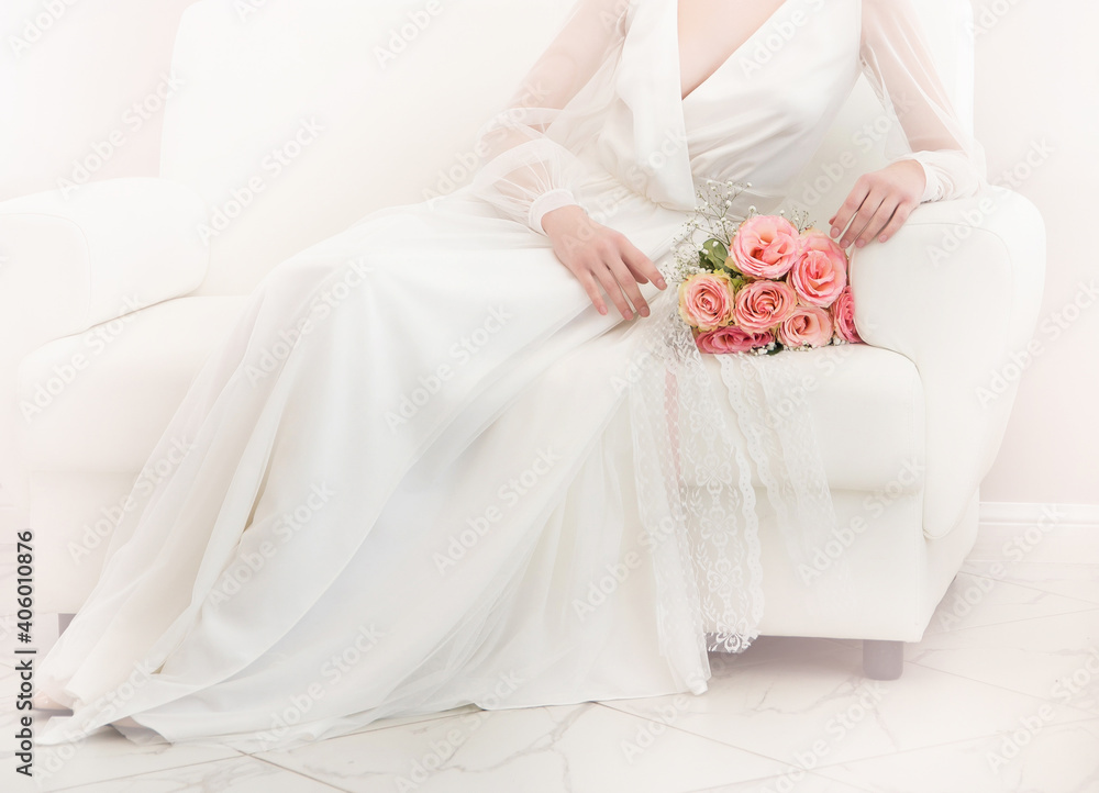 wedding photo with a white dress and a bouquet of pink roses on a light background wedding photo with a white dress and a bouquet of pink roses on a light background