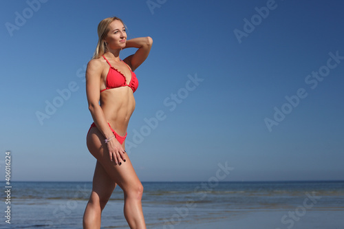 young woman in red swimsuit on the beach © zhagunov_a