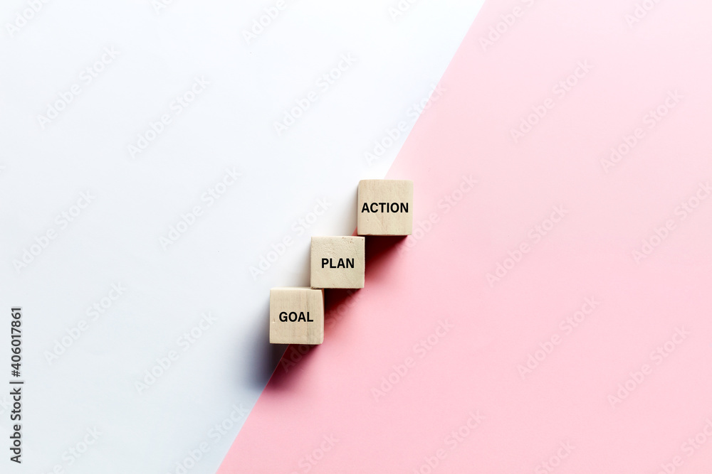 The words goal, plan and action on wooden cubes against pink and white background. Business or marketing planning strategy - obrazy, fototapety, plakaty 