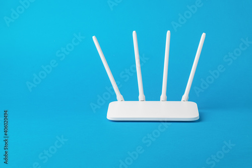 Bild auf Leinwand White Wi-Fi router with external antennas on a blue background.