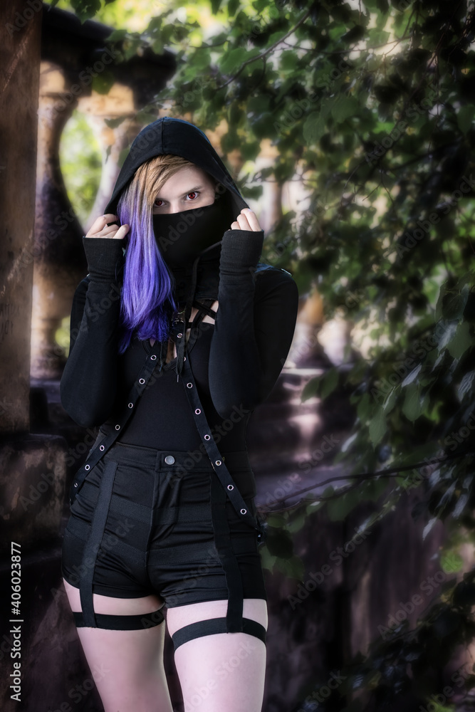Portrait woman in a black mask and black dress. Portrait woman in a black mask and black dress.