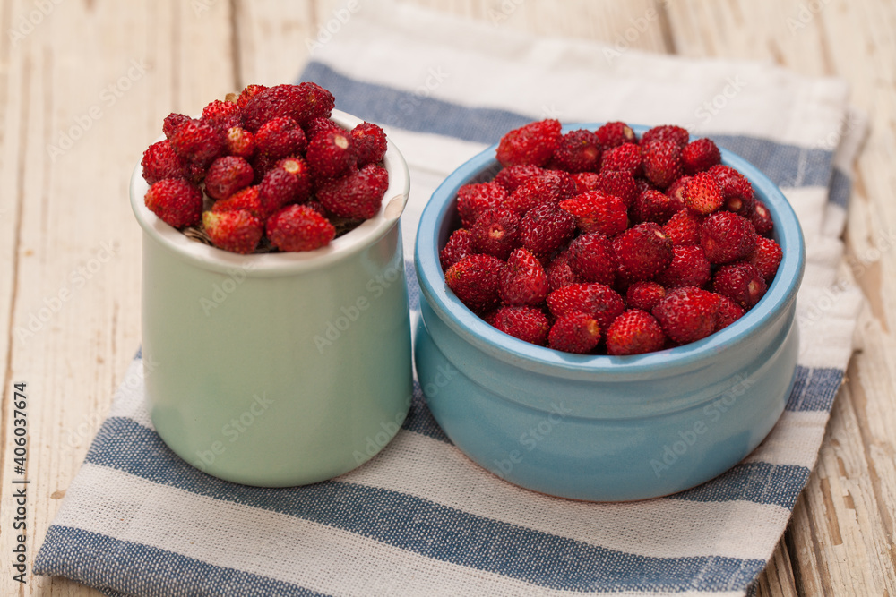 Fresh bilberries and strawberries in blue bowls, healthy eating concept Fresh bilberries and strawberries in blue bowls, healthy eating concept
