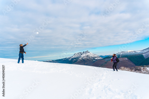 Young people throwing snowballs in the Oianleku natural park in the town of Oiartzun, next to Peñas de Aya in winter, Gipuzkoa. Basque Country