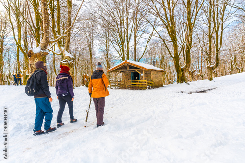 Young people visiting the snow-covered Oianleku natural park in the town of Oiartzun, next to Peñas de Aya in winter, Gipuzkoa. Basque Country
