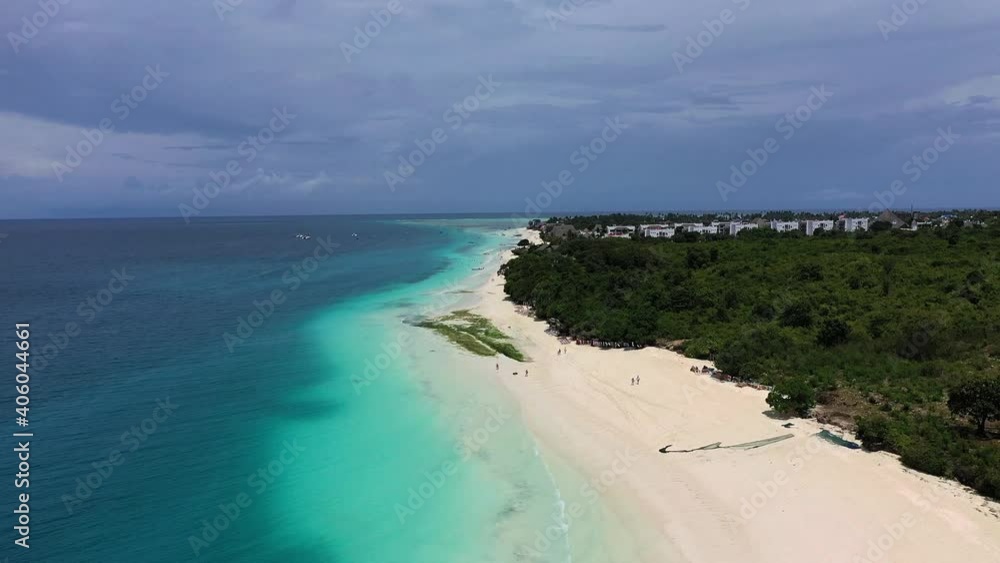 Aerial view of Nungwi village discrict, Blue Lagoon, North part of Zanzibar, White beach, Palm paradise, Tanzania from above Aerial view of Nungwi village discrict, Blue Lagoon, North part of Zanzibar, White beach, Palm paradise, Tanzania from above