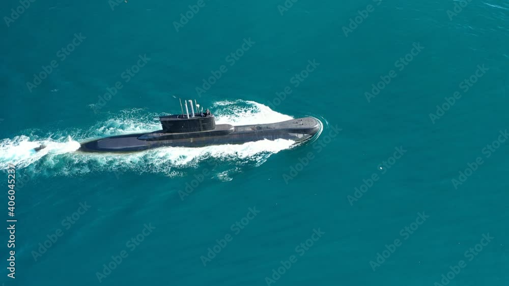 Aerial drone video of latest technology naval armed forces submarine cruising in deep blue open ocean sea Aerial drone video of latest technology naval armed forces submarine cruising in deep blue open ocean sea