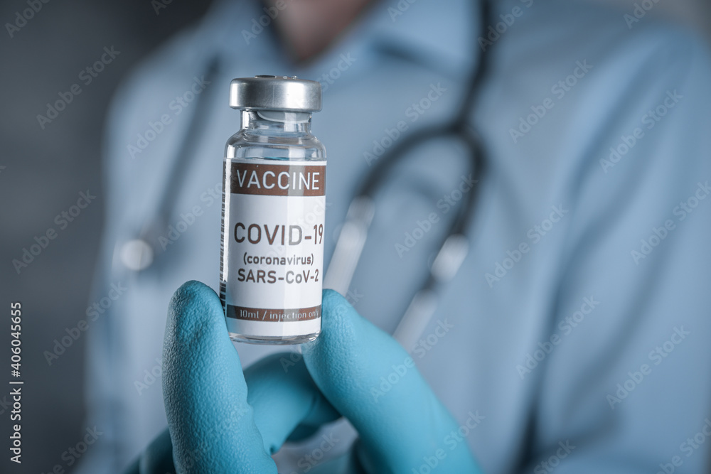 Doctor with a stethoscope on shoulder holding in hand COVID-19 , coronavirus, SARS-cov-2 vaccine. Healthcare And Medical concept.Development and creation vaccine Doctor with a stethoscope on shoulder holding in hand COVID-19 , coronavirus, SARS-cov-2 vaccine. Healthcare And Medical concept.Development and creation vaccine