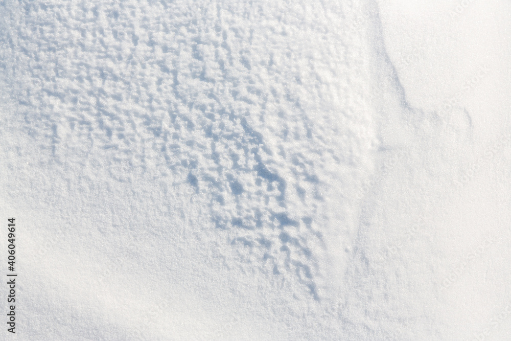 Beautiful winter background with snowy ground. Natural snow texture. Wind sculpted patterns on snow surface. Beautiful winter background with snowy ground. Natural snow texture. Wind sculpted patterns on snow surface.