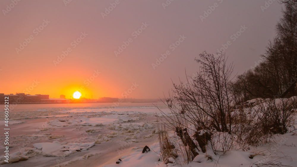 Dawn over a frozen river. Winter landscape. Dawn over a frozen river. Winter landscape.