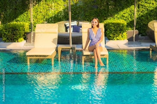 Portrait beautiful young asian woman relax smile leisure on vacation around swimming pool