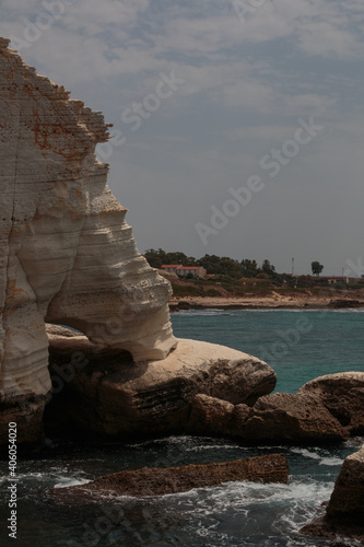 Rosh HaNikra – entrance to the caves from the Mediterranean sea, between limestone cliffs and heavy stones at water level.