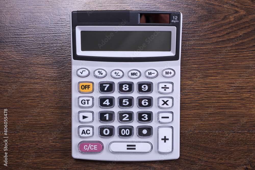 Calculator keypad on a wooden floor background. Top view. Copy space Calculator keypad on a wooden floor background. Top view. Copy space