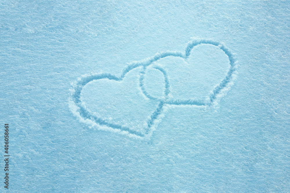 Drawing of two hearts in the snow. Valentine's day concept. Love symbol. Texture. Postcard, place for text.