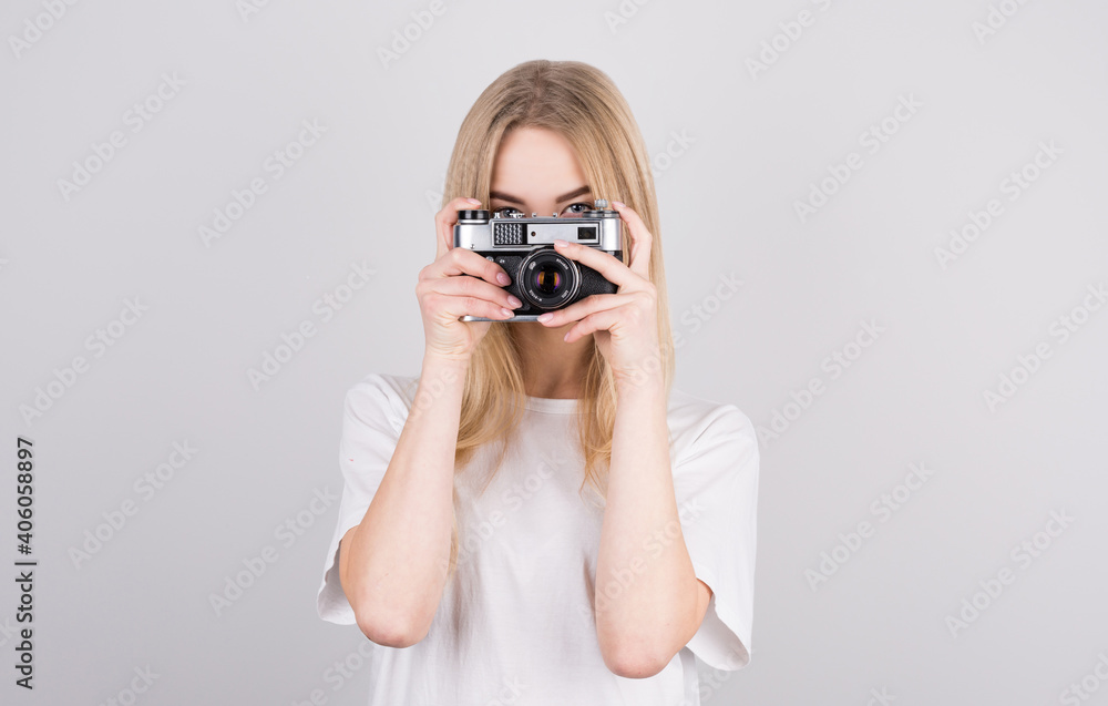 © Studio Nova - Happy smiling young girl holding camera and taking photos