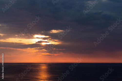 beautiful orange sunset over the dark sea wit an orange line of reflection. Horizontal picture.