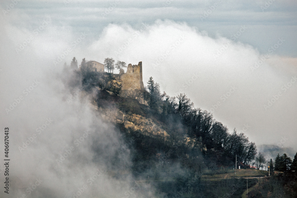 Obraz Medieval Canossa Castle in fog in cold winter, Reggio Emilia, Italy