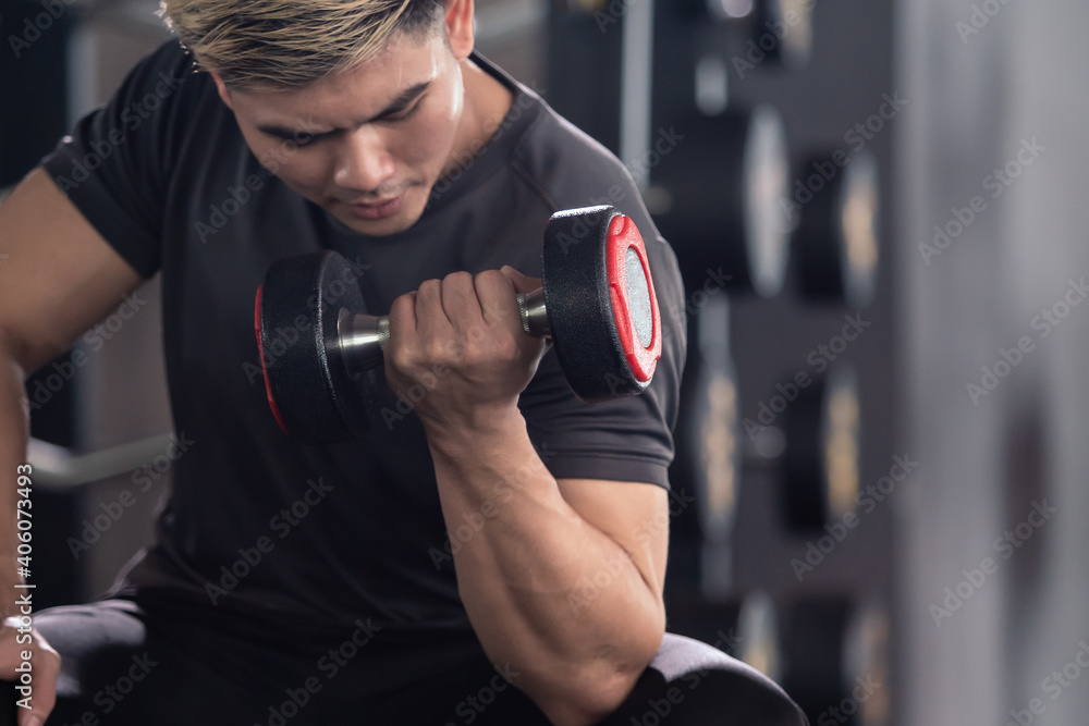 Asian young man practice weight training workout in the gym. Asian young man practice weight training workout in the gym.