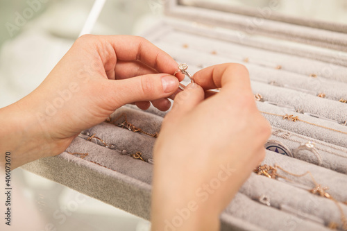 Close up of a diamond ring in the hands of female customer