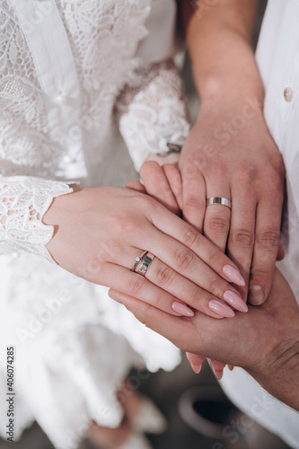 close-up of the hands of the bride and groom with wedding rings