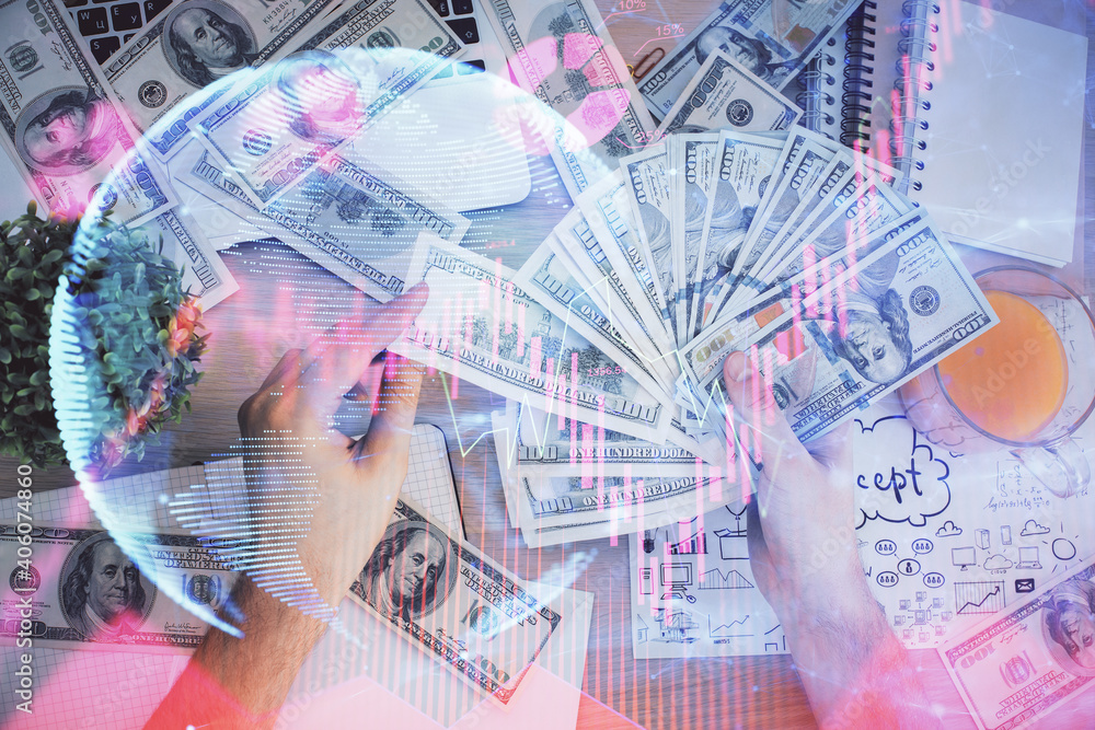 Multi exposure of financial theme drawing hologram and USA dollars bills and man hands. Business concept. Multi exposure of financial theme drawing hologram and USA dollars bills and man hands. Business concept.