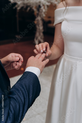 the bride and groom wear wedding rings