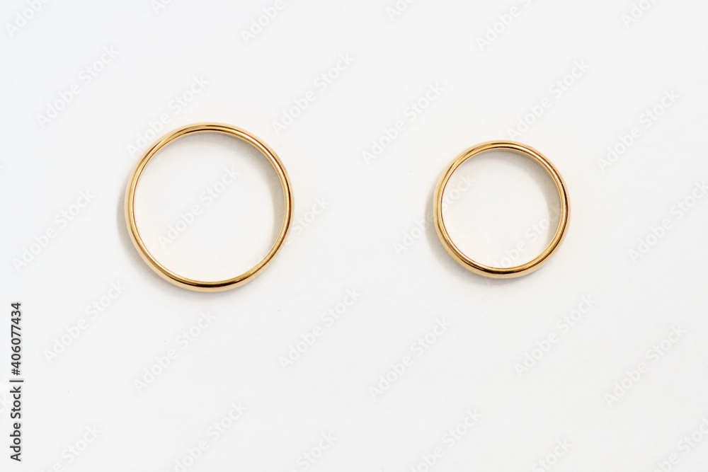 Gold rings top view over white paper. For design or lettering. Gold rings top view over white paper. For design or lettering.