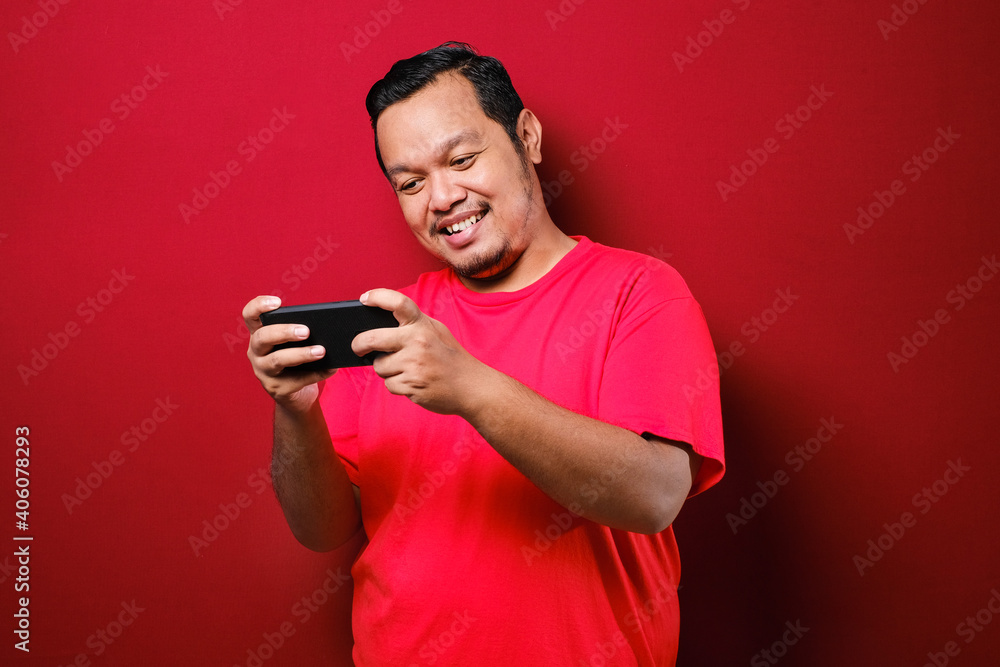 Portrait of Asian man browsing Internet on smartphone Portrait of Asian man browsing Internet on smartphone
