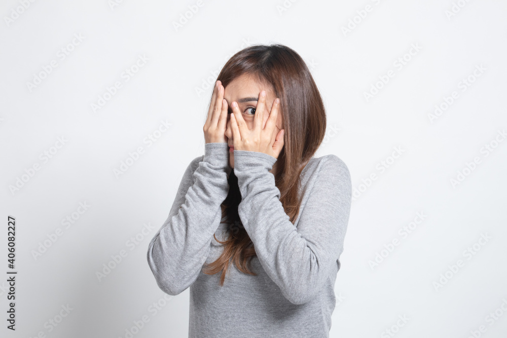 Beautiful young Asian woman peeking through fingers. Beautiful young Asian woman peeking through fingers.