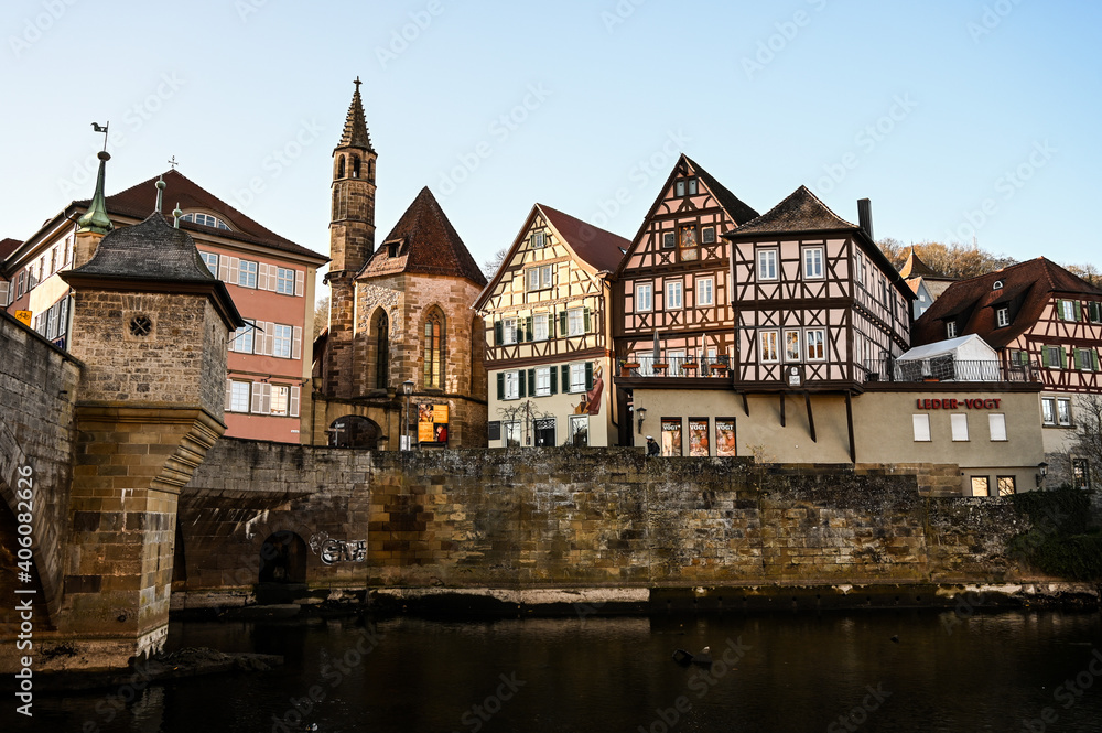 Cityscape of Schwäbisch Hall, Germany showing colorful half-timbered houses and and a historical bell tower of a church.