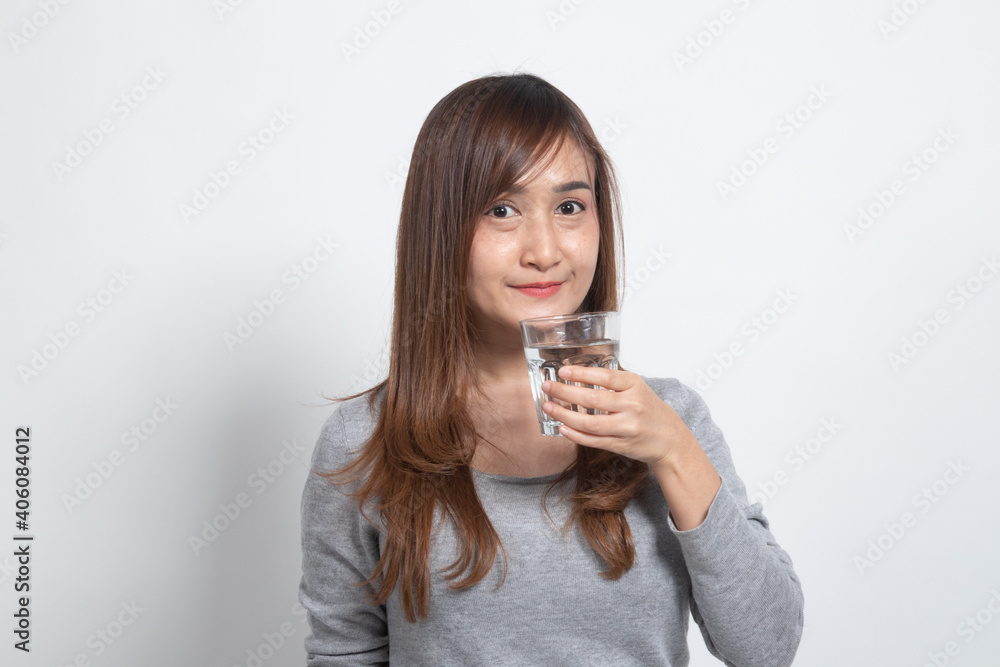 Young Asian woman with a glass of drinking water. Young Asian woman with a glass of drinking water.