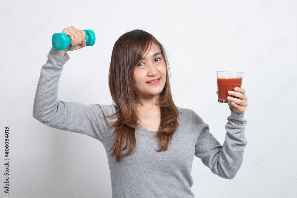 Healthy Asian woman with dumbbell and tomato juice. Healthy Asian woman with dumbbell and tomato juice.