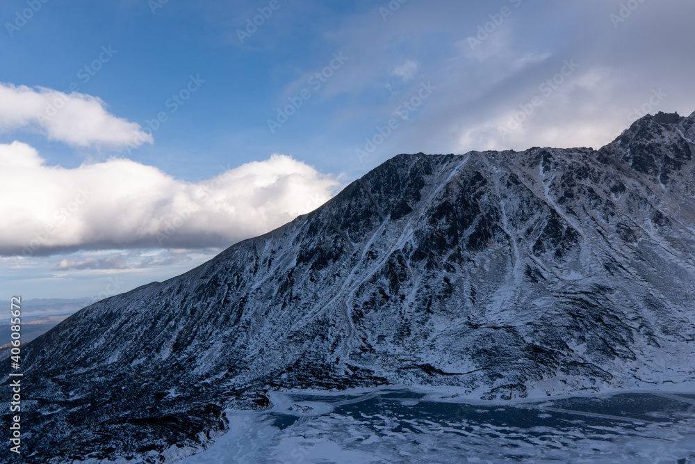 Winter and Snow at Black Pond or Czarny Staw at Rysy Peak in Poland. Panoramic winter landscape with frozen lake