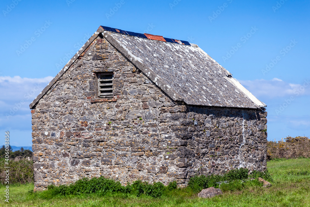 Stone barn shed in a summer pasture field on Caldey Island of the coast of Tenby Pembrokeshire South Wales, stock photo image Stone barn shed in a summer pasture field on Caldey Island of the coast of Tenby Pembrokeshire South Wales, stock photo image