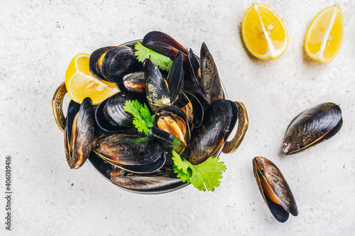 Delicious cooked seafood mussels with lemon and parsley. Clams in the shells. Copy space