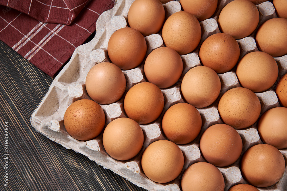 Brown chicken eggs lie in a cardboard egg tray, close-up, organic protein of natural origin, free space for text. Brown chicken eggs lie in a cardboard egg tray, close-up, organic protein of natural origin, free space for text.