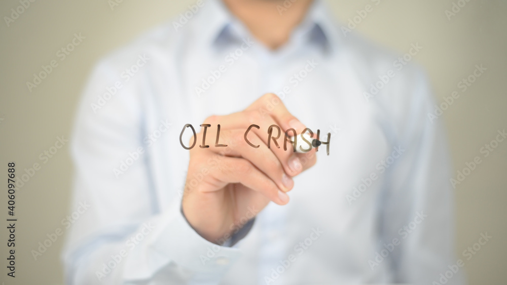 Oil Crash , Man writing on transparent screen Oil Crash , Man writing on transparent screen