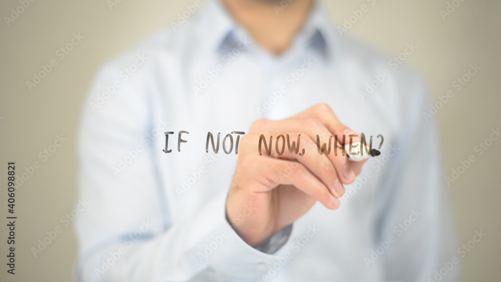 If Not Now, When , Man writing on transparent screen If Not Now, When , Man writing on transparent screen