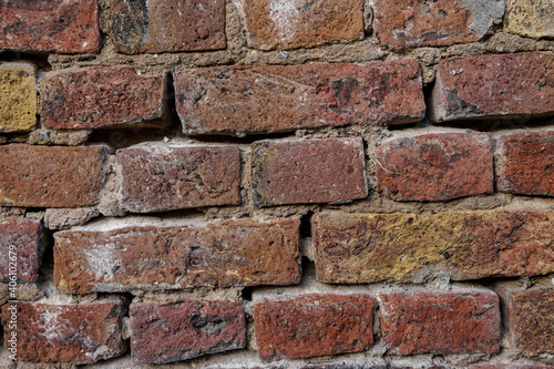 Brick texture. Old red orange brown worn and weathered brick wall, clinker bricks.