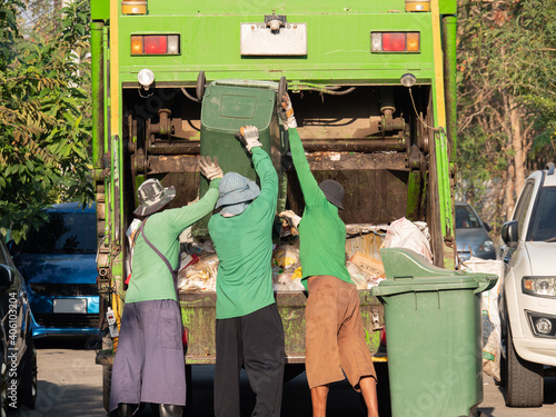garbage collection service the garbage collector team pickup trash to dispose waste into garbage truck for cleanup urban city and environment conservation