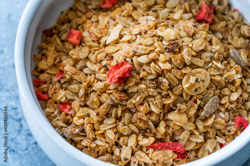 Oven Baked Artisan Granola with Dried Strawberries and Chia Seeds in Bowl. Oven Baked Artisan Granola with Dried Strawberries and Chia Seeds in Bowl.