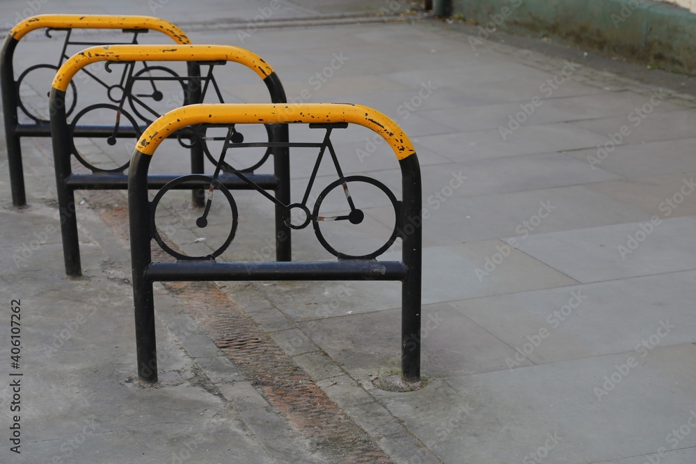  A closeup view of some yellow and black bicycle stands.