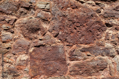 A closeup view of a red stone wall.