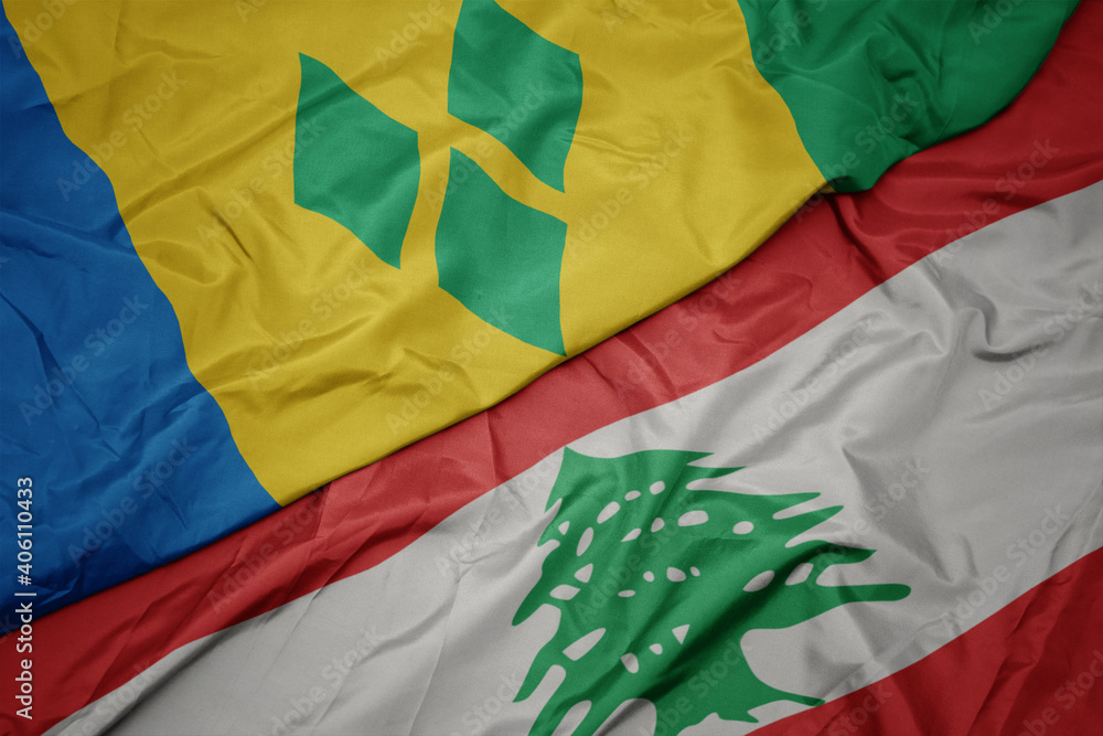 waving colorful flag of lebanon and national flag of saint vincent and the grenadines.
