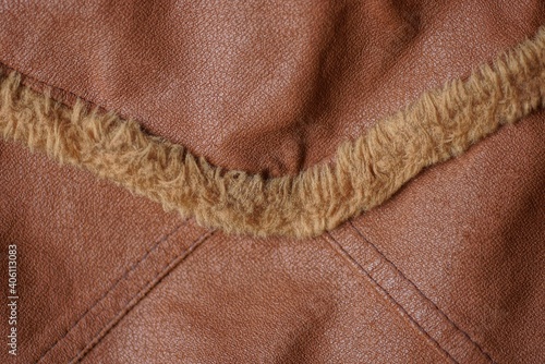 brown leather texture with a seam and a strip of fur on the clothes