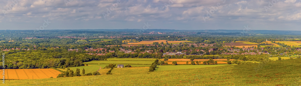 A panorama view from the top of the South down across the Weald near Brighton, UK in summertime