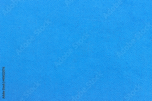 The surface of the blue old worn dermatin with a small pattern. photo
