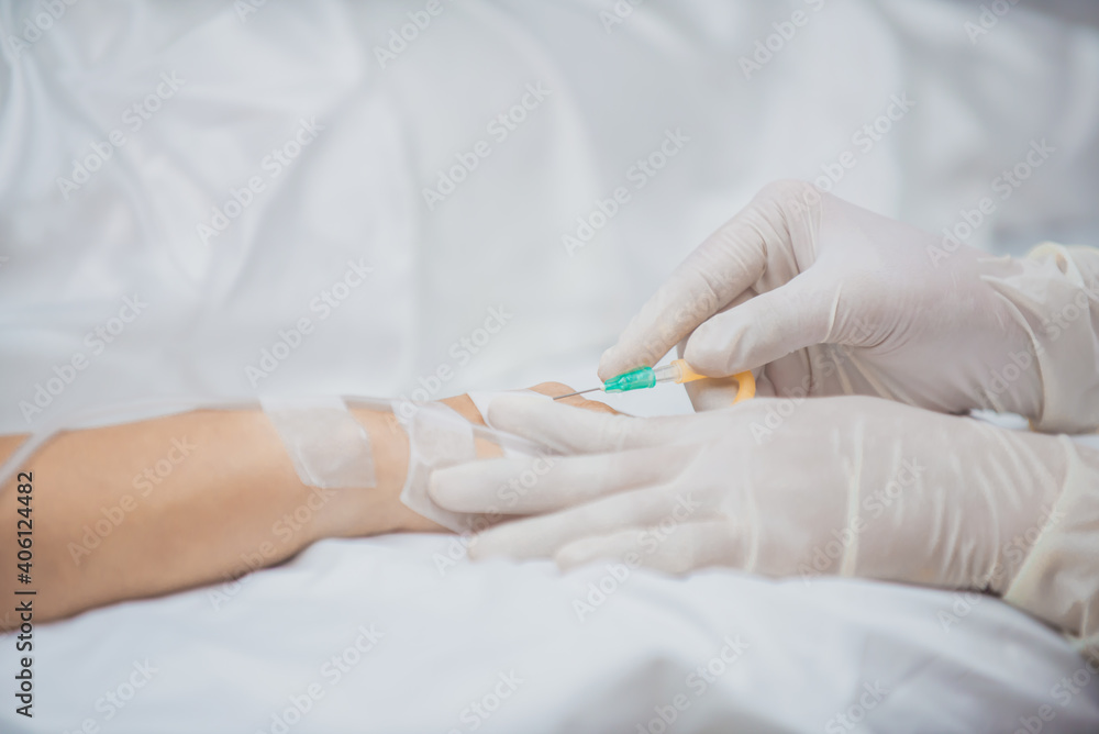 close up of a nurse holding a syringe close up of a nurse holding a syringe