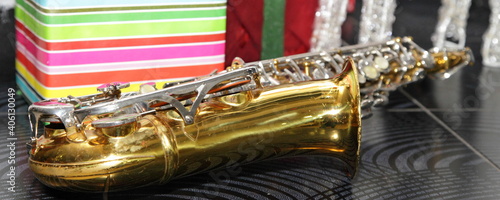 Photography One Golden saxophone close up on gifts background, jazz music on celebration