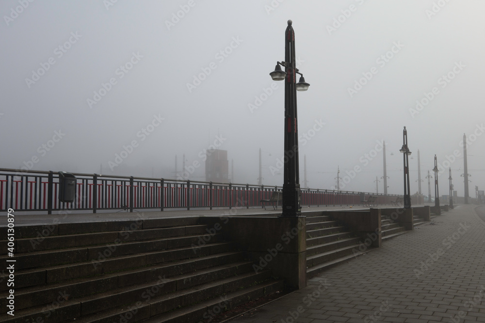 Berlage Bridge at the Amstel river in Amsterdam, The Netherlands in the mist