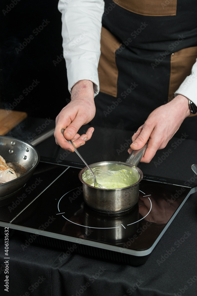 man cooking meat and sauce on a induction cooker man cooking meat and sauce on a induction cooker